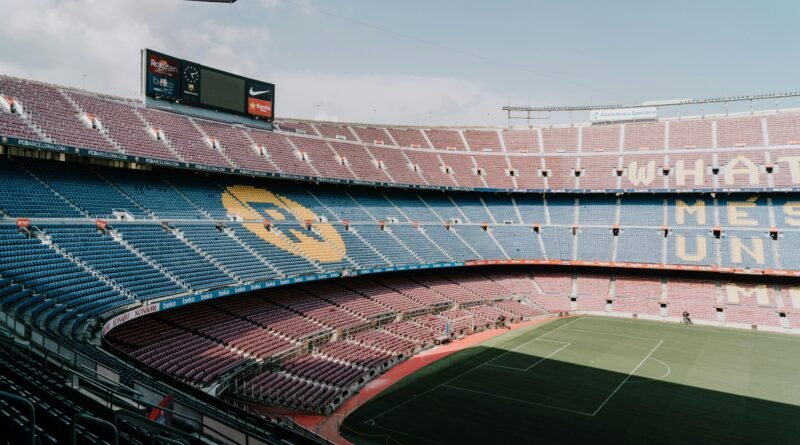View of Camp Nou stadium in Barcelona, showcasing the iconic stands and field.